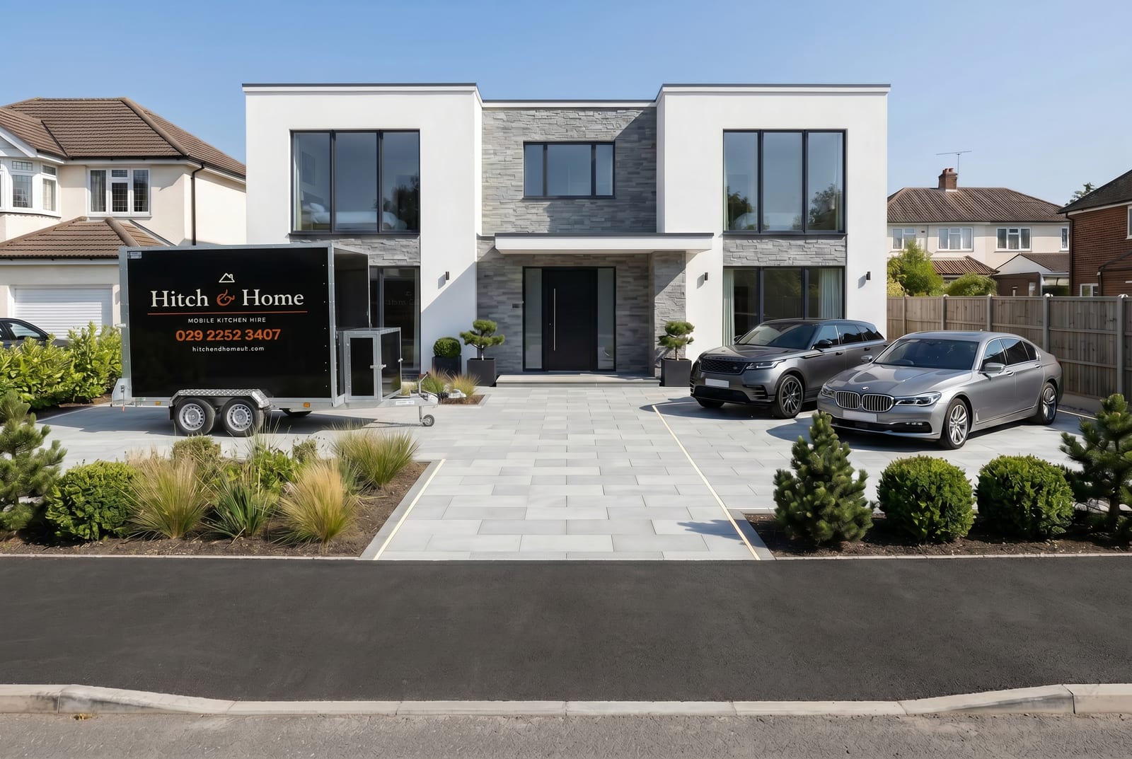 Hitch and Home trailer on a large driveway with landscaped planting