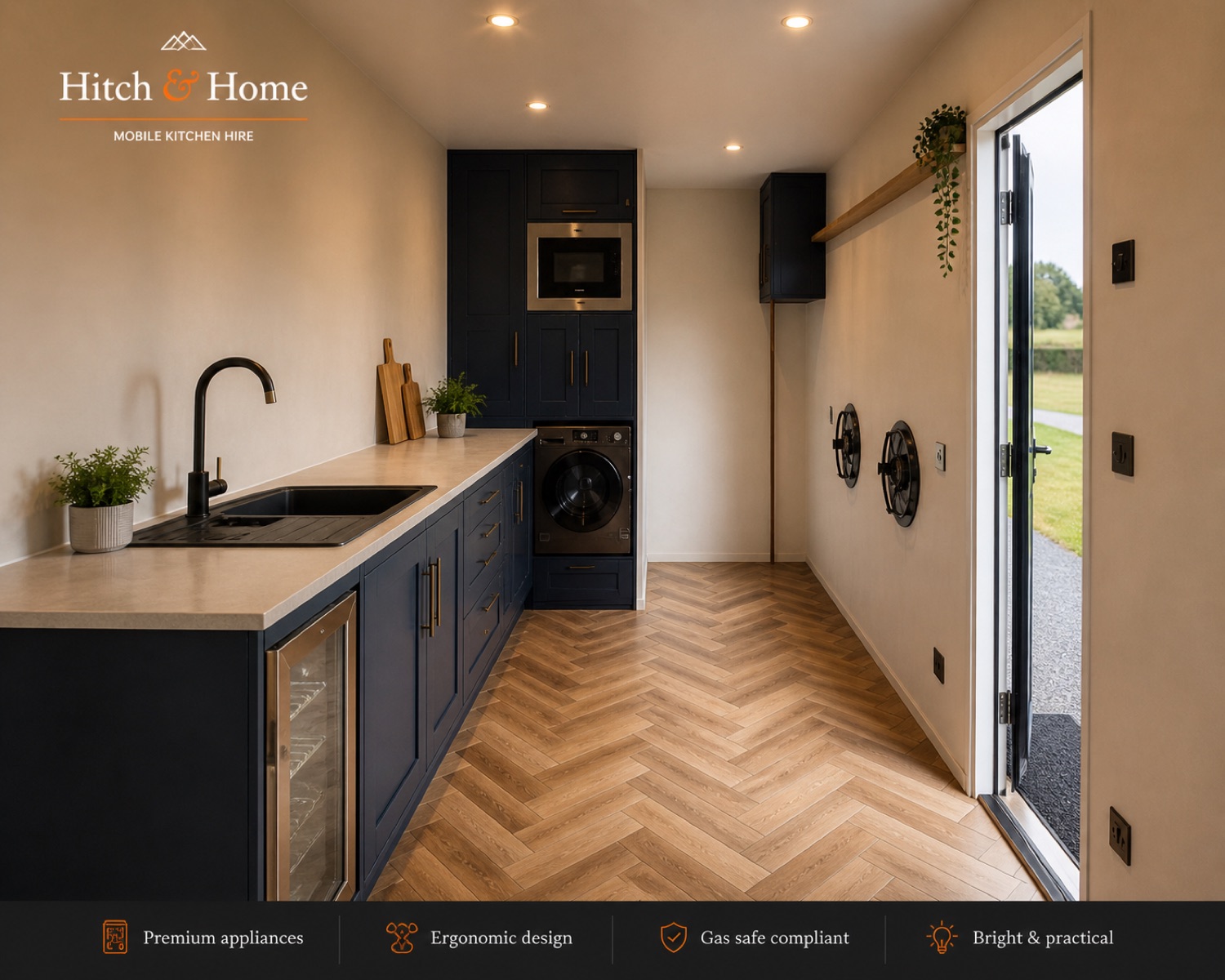 The navy and copper fitted kitchen inside a Hitch and Home trailer